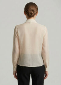 woman-wearing-cream-ruffle-blouse-back-plain